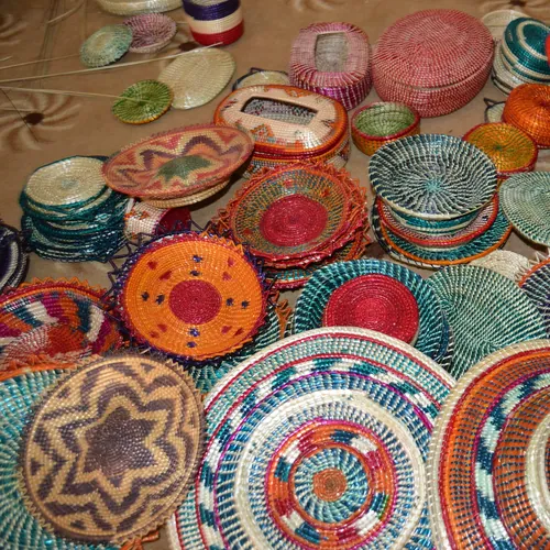 Colourful coiled Harari baskets in turquoise, orange and red patterns